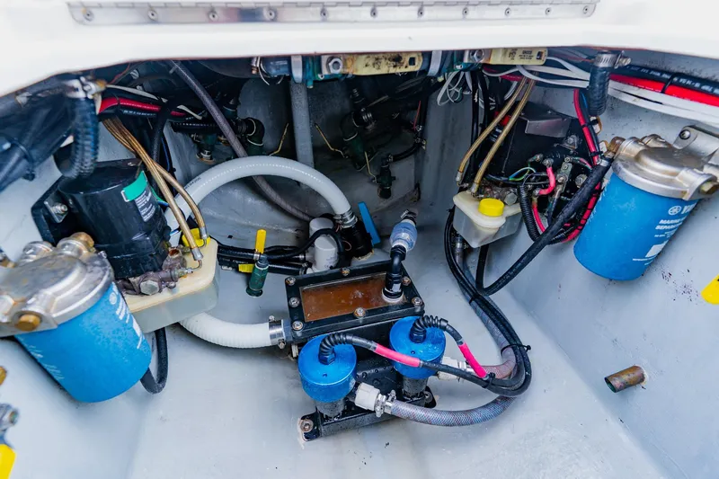 Slide: The Image of Engine compartment of 2025 Contender 32 ST boat, showcasing fuel filters and wiring. - 49