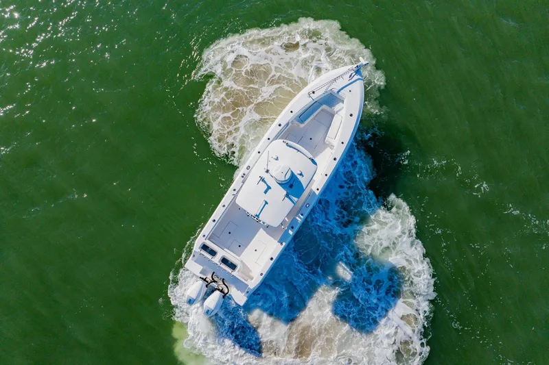 Slide: The Image of Aerial view of 2025 Contender 32 ST boat navigating through green waters. - 9