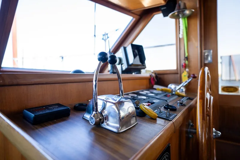 Slide: The Image of 1991 Lien Hwa Cockpit Sundeck yacht helm with controls and wooden steering wheel. - 10