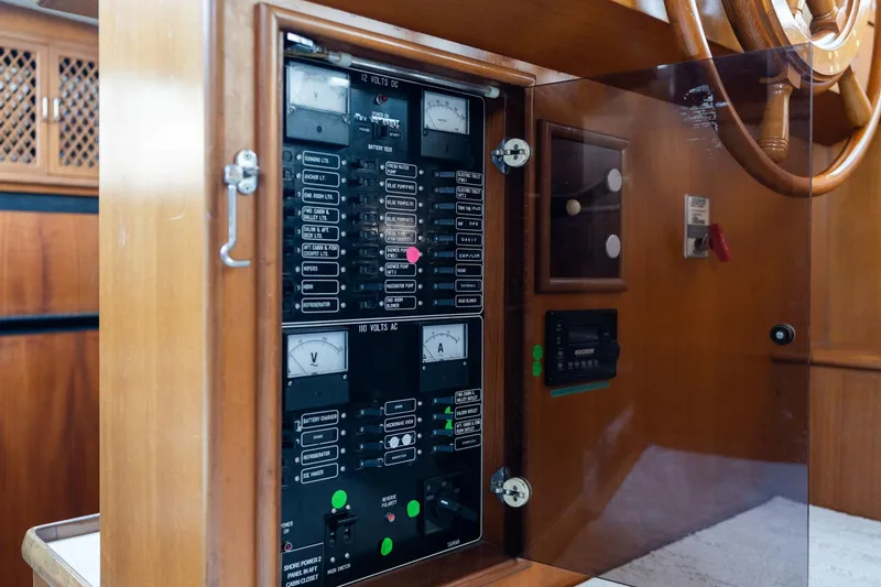 Slide: The Image of Control panel of a 1991 Lien Hwa Cockpit Sundeck yacht, featuring gauges and switches. - 15