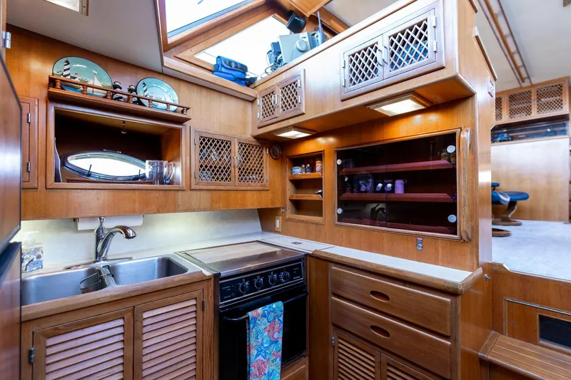 Slide: The Image of Luxurious 1991 Lien Hwa Cockpit Sundeck yacht kitchen with wood cabinetry and modern amenities. - 16