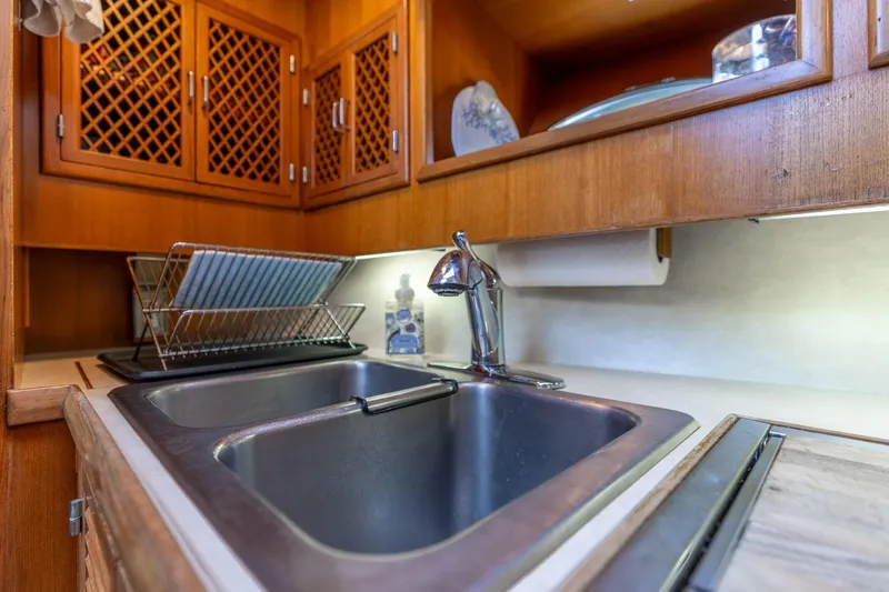 Slide: The Image of Kitchen sink area in 1991 Lien Hwa Cockpit Sundeck yacht with wooden cabinets. - 18