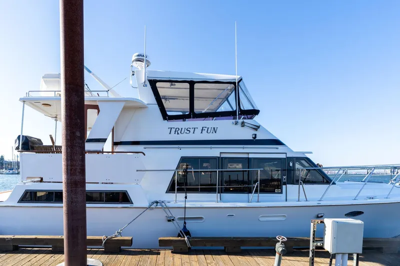 Slide: The Image of 1991 Lien Hwa Cockpit Sundeck yacht docked, named "Trust Fun," with clear blue sky background. - 2