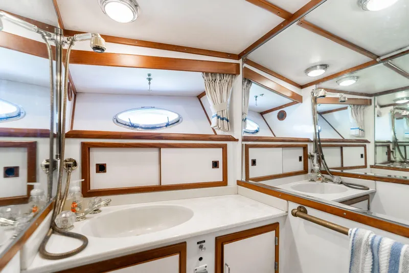 Slide: The Image of Luxurious bathroom interior of 1991 Lien Hwa Cockpit Sundeck yacht with wood accents and mirrors. - 23