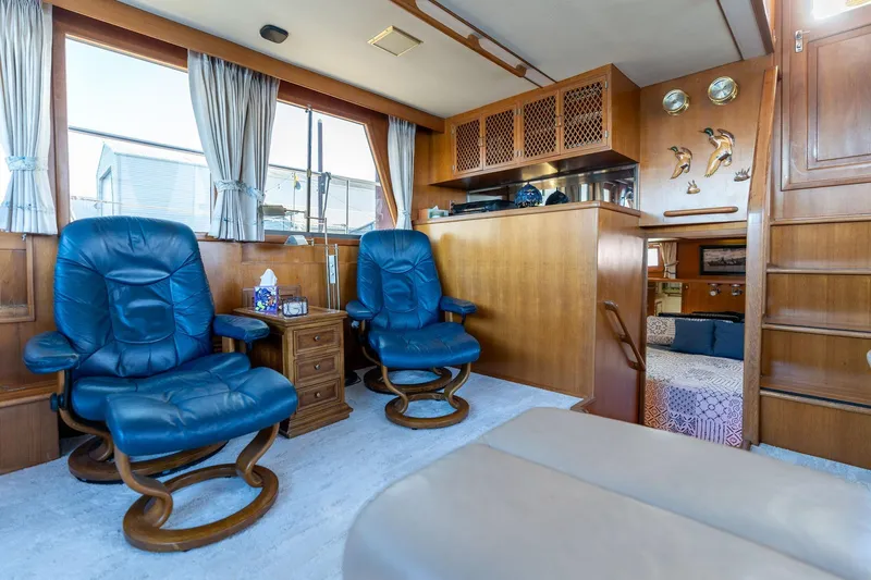 Slide: The Image of Luxurious 1991 Lien Hwa Cockpit Sundeck interior with blue leather chairs and wooden accents. - 24