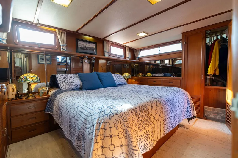 Slide: The Image of Luxurious 1991 Lien Hwa Cockpit Sundeck yacht bedroom with elegant wood interior and cozy bedding. - 26