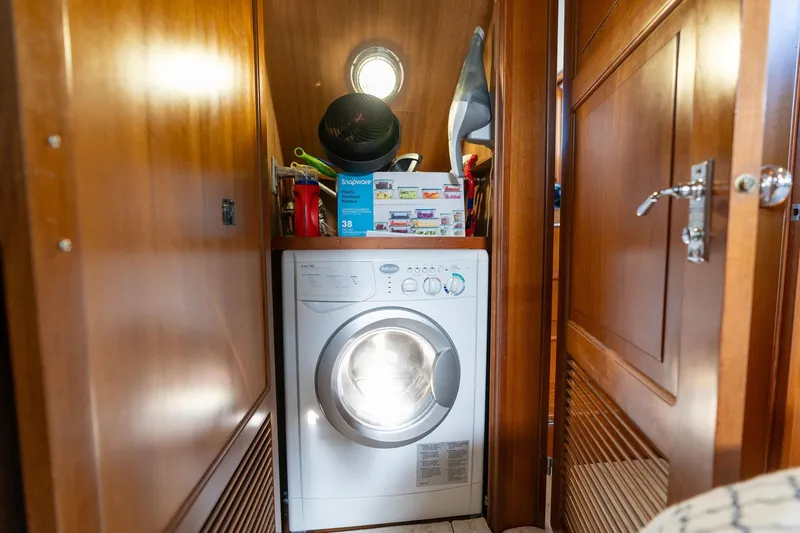 Slide: The Image of Laundry area inside 1991 Lien Hwa Cockpit Sundeck yacht with wooden cabinetry. - 28