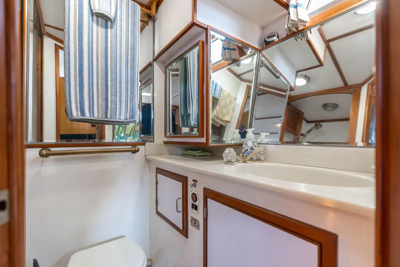 Slide: The Image of Bathroom interior of 1991 Lien Hwa Cockpit Sundeck yacht with mirrors and striped towel. - 29