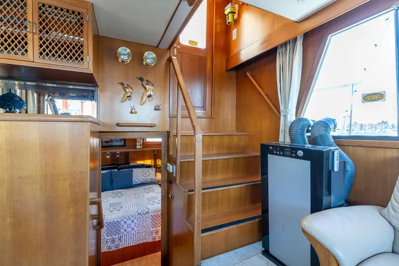 Slide: The Image of 1991 Lien Hwa Cockpit Sundeck interior with wooden stairs, cozy cabin, and nautical decor. - 31