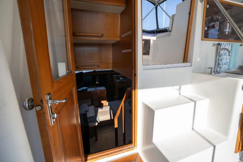 Slide: The Image of 1991 Lien Hwa Cockpit Sundeck interior with wooden cabinetry and steps. - 32