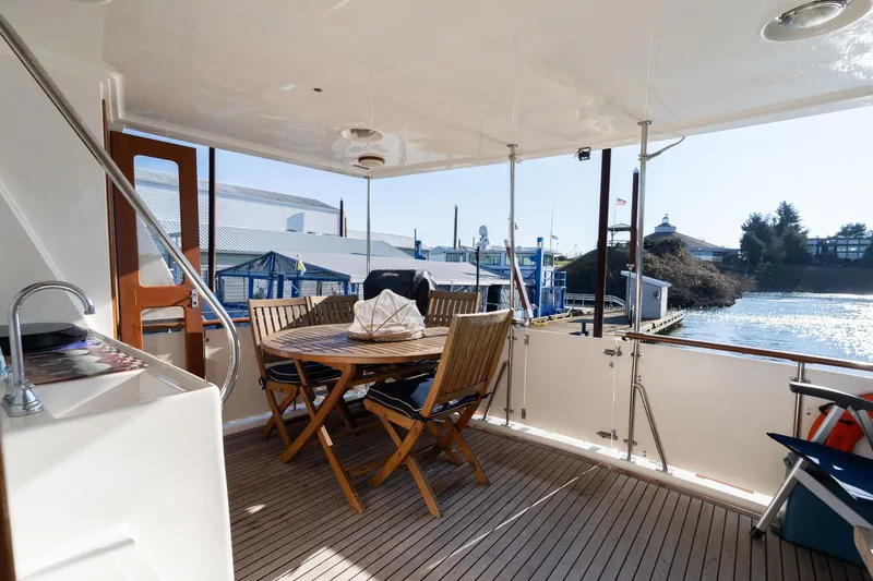 Slide: The Image of 1991 Lien Hwa Cockpit Sundeck with outdoor seating, docked by the water. - 33