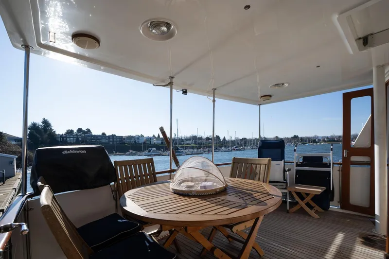 Slide: The Image of 1991 Lien Hwa Cockpit Sundeck with wooden furniture, overlooking marina and clear sky. - 34