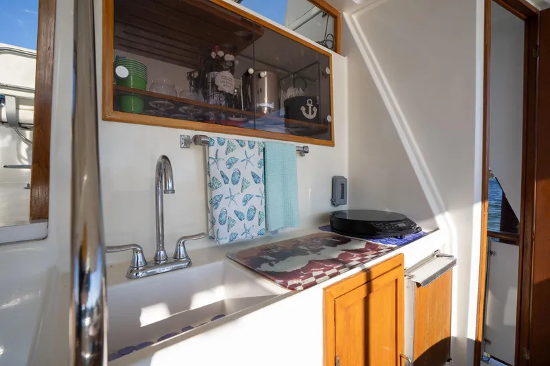 Slide: The Image of 1991 Lien Hwa Cockpit Sundeck interior with sink, cabinets, and nautical decor. - 35