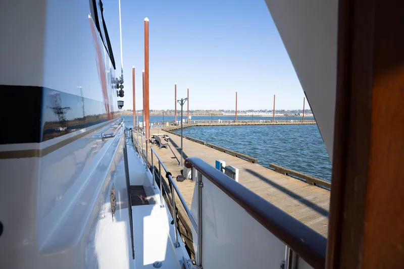 Slide: The Image of 1991 Lien Hwa Cockpit Sundeck yacht docked at a marina with clear blue skies. - 44