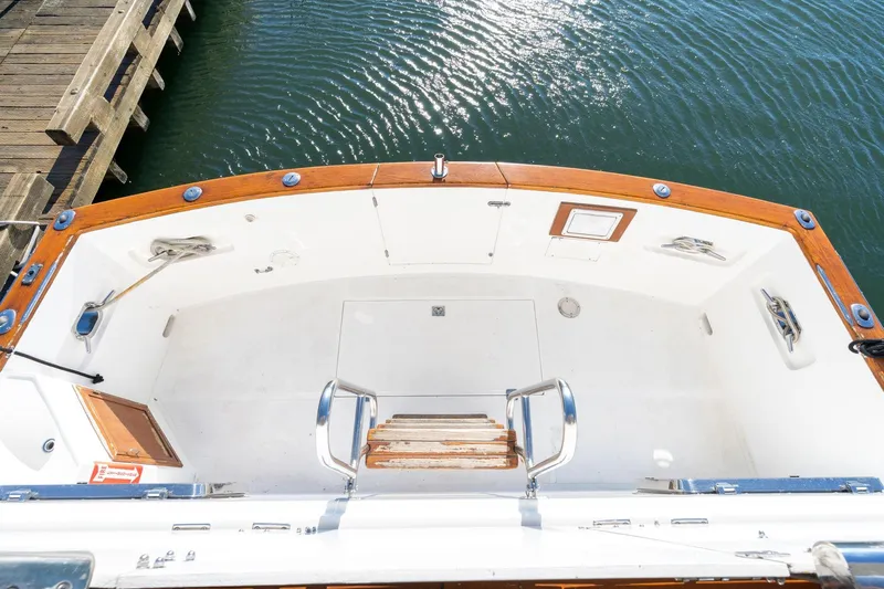 Slide: The Image of 1991 Lien Hwa Cockpit Sundeck boat with wooden trim, docked by the water. - 49