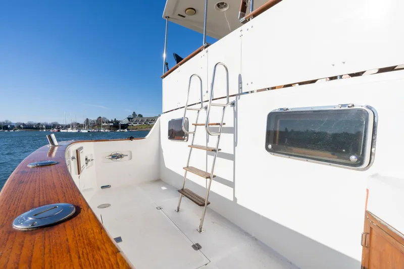 Slide: The Image of 1991 Lien Hwa Cockpit Sundeck yacht with ladder and wooden deck, docked by the water. - 50