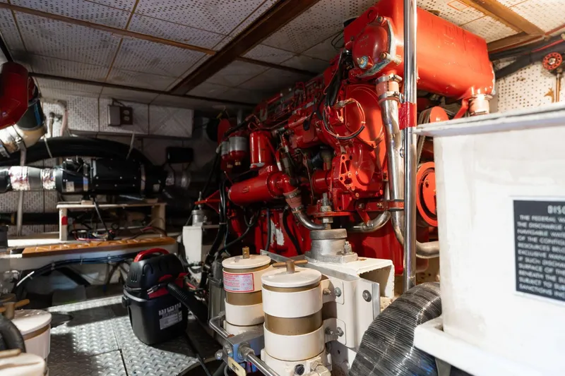 Slide: The Image of Engine room of a 1991 Lien Hwa Cockpit Sundeck yacht, featuring red machinery and equipment. - 54