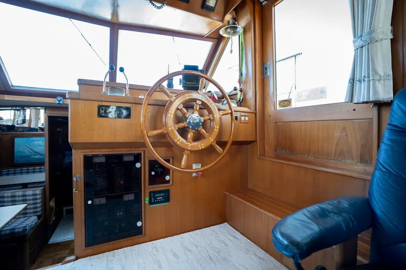 Slide: The Image of 1991 Lien Hwa Cockpit Sundeck interior with wooden helm and nautical controls. - 9