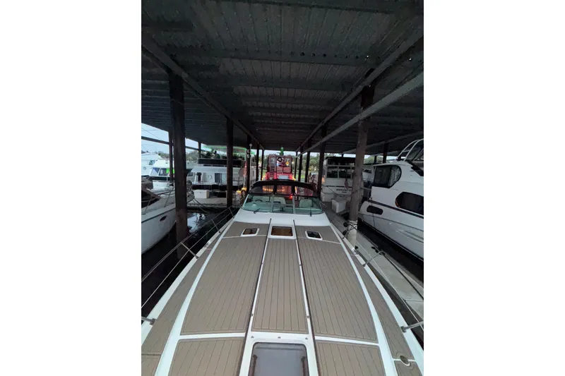 Slide: The Image of 1995 Sea Ray Sundancer 370 docked under a covered marina. - 11