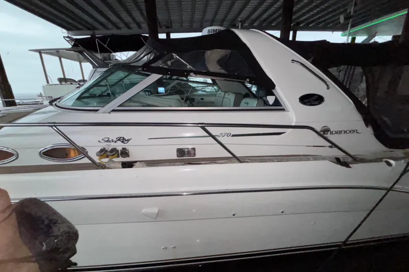 Slide: The Image of 1995 Sea Ray Sundancer 370 boat docked under a covered marina. - 2