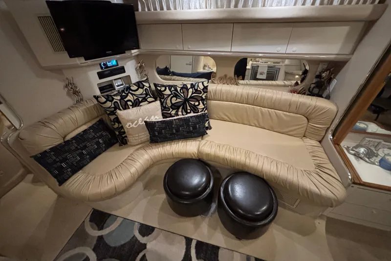 Slide: The Image of Interior of 1995 Sea Ray Sundancer 370 with beige seating and decorative pillows. - 26