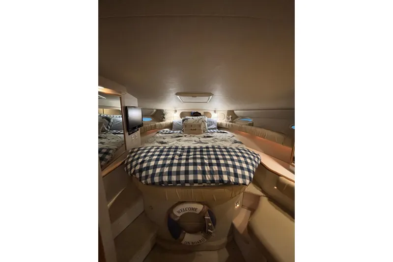 Slide: The Image of Interior of 1995 Sea Ray Sundancer 370 with cozy bed and nautical decor. - 28