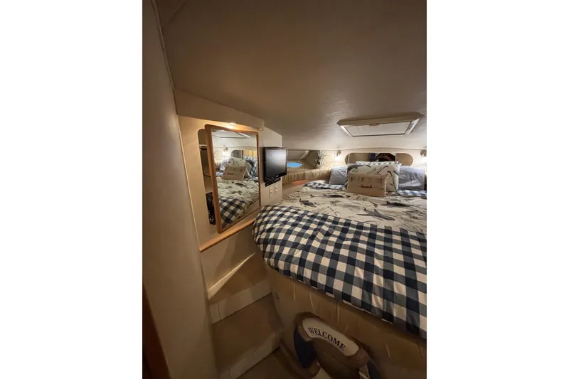 Slide: The Image of Interior cabin of 1995 Sea Ray Sundancer 370 with cozy bedding and mirror. - 29