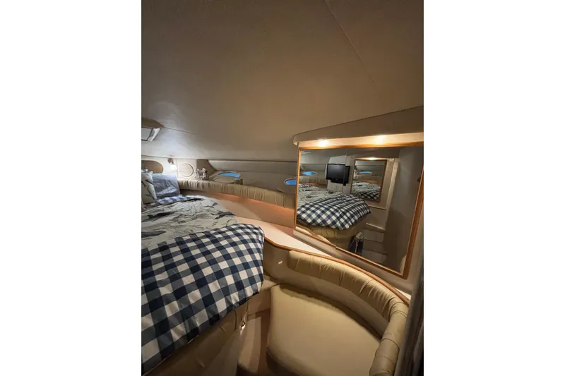Slide: The Image of 1995 Sea Ray Sundancer 370 cabin interior with cozy bed and mirror reflection. - 30