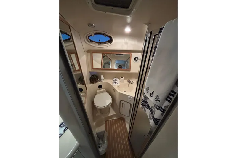 Slide: The Image of Interior of 1995 Sea Ray Sundancer 370 bathroom with nautical decor and compact design. - 31