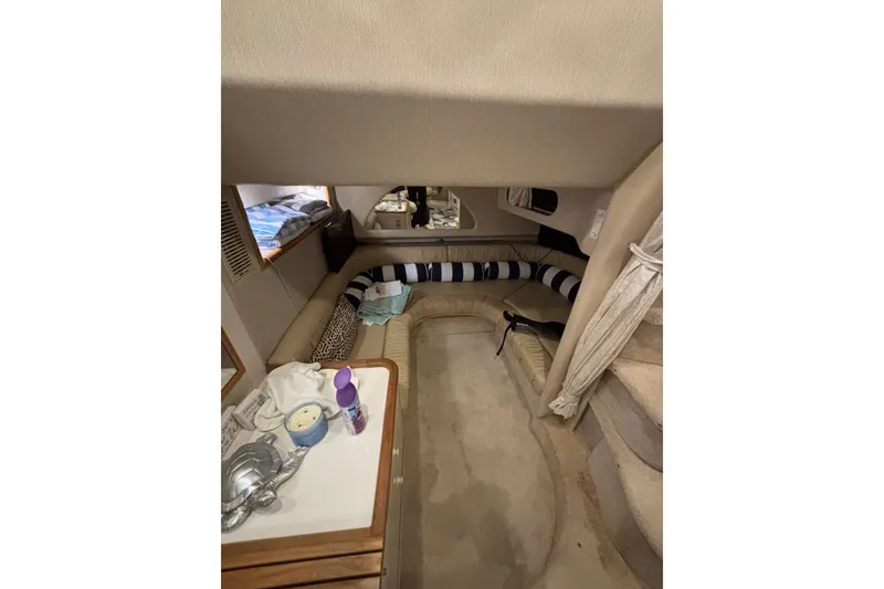 Slide: The Image of Interior of 1995 Sea Ray Sundancer 370 with cozy seating and nautical decor. - 32