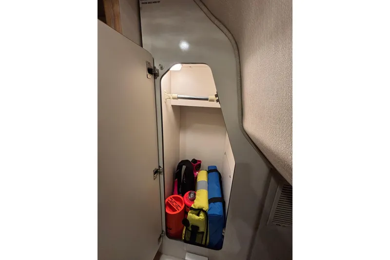 Slide: The Image of Storage compartment in 1995 Sea Ray Sundancer 370 with life jackets and safety equipment. - 33