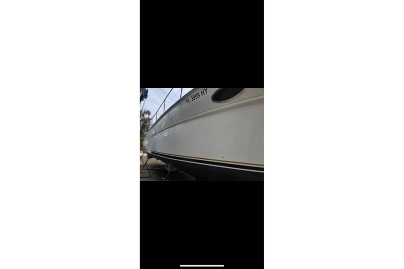 Slide: The Image of 1995 Sea Ray Sundancer 370 boat side view with registration number visible. - 37
