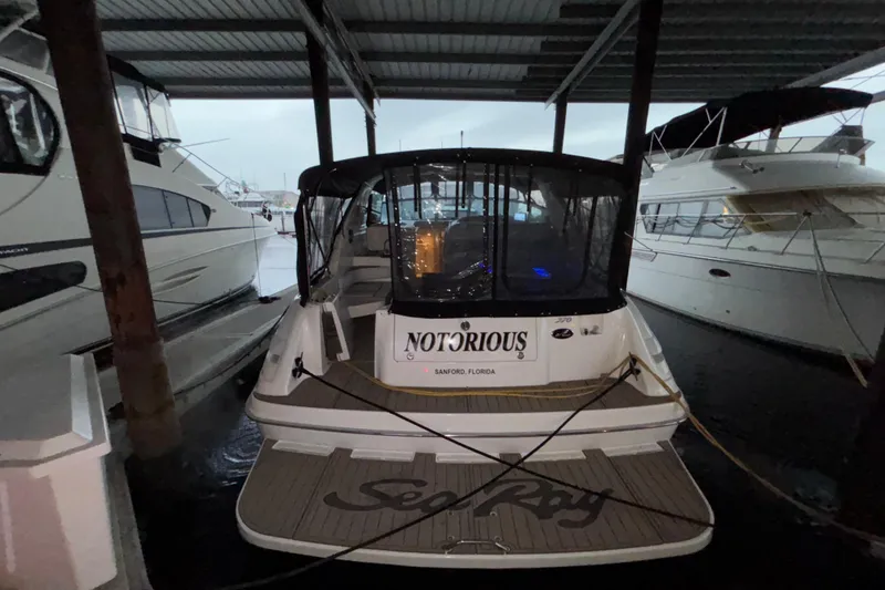 Slide: The Image of 1995 Sea Ray Sundancer 370 docked, rear view with "Notorious" name visible. - 4