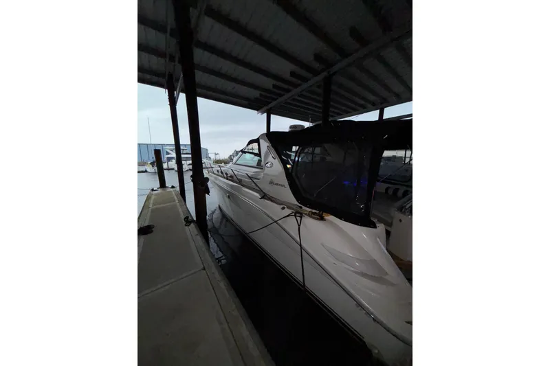 Slide: The Image of 1995 Sea Ray Sundancer 370 docked under a covered marina. - 6