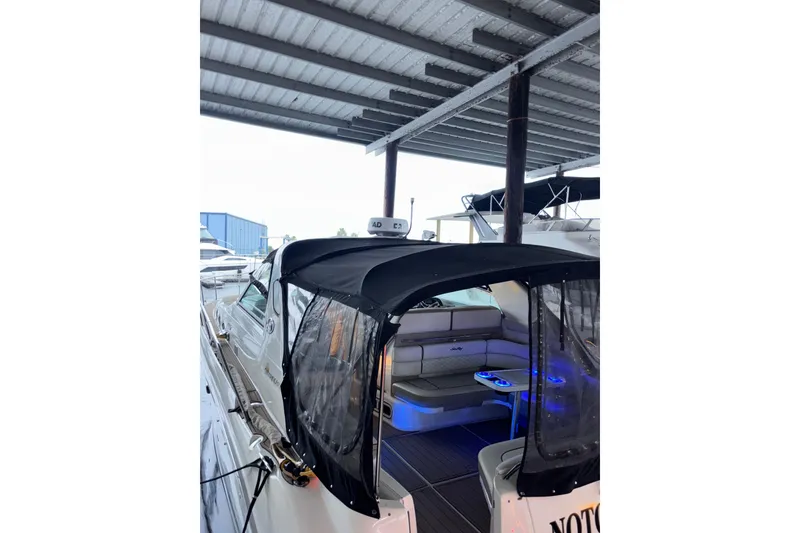 Slide: The Image of 1995 Sea Ray Sundancer 370 yacht with covered seating area in marina. - 7