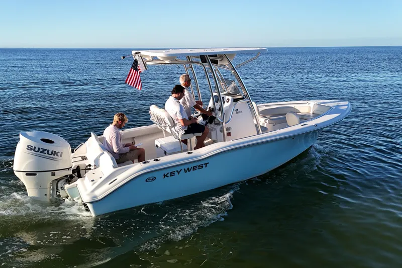 The Image of 2020 Key West 219 FS boat cruising on open water with passengers. - 0