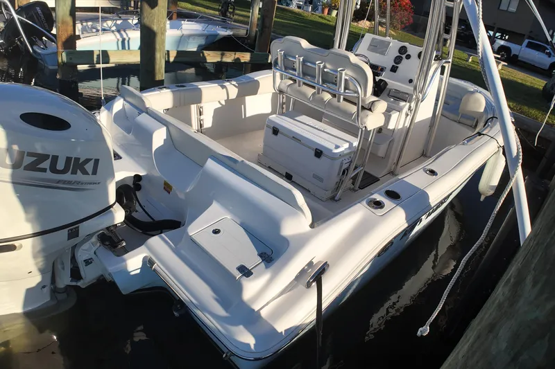 Slide: The Image of 2020 Key West 219 FS boat with Suzuki engine docked in marina. - 10
