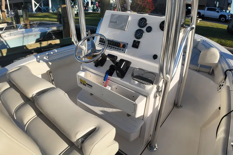 Slide: The Image of 2020 Key West 219 FS boat interior with steering console and seating. - 12