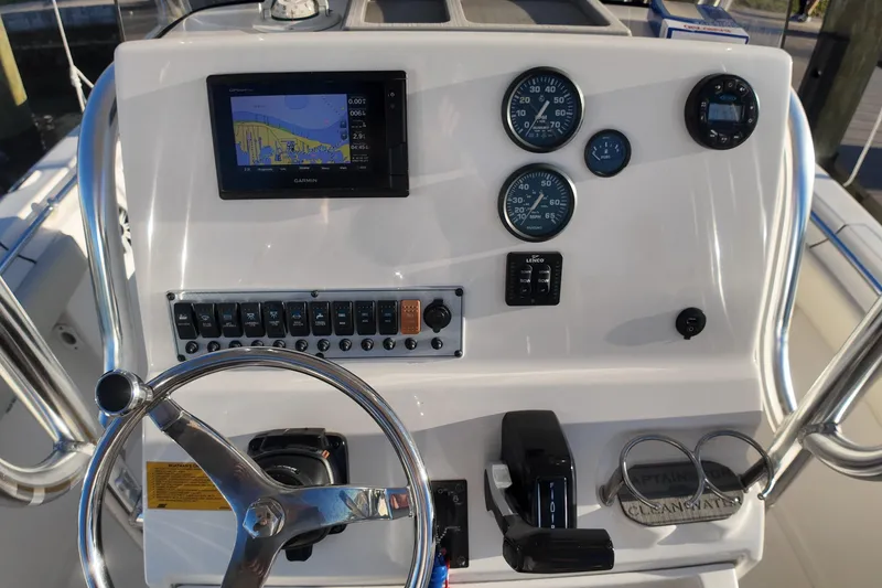 Slide: The Image of 2020 Key West 219 FS boat dashboard with Garmin GPS, gauges, and controls. - 13