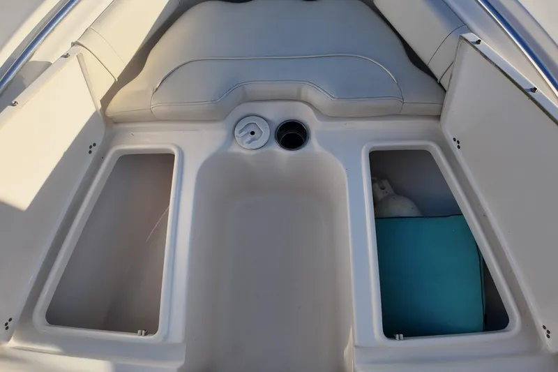 Slide: The Image of 2020 Key West 219 FS boat interior with storage compartments and seating. - 17
