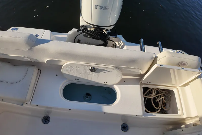 Slide: The Image of 2020 Key West 219 FS boat interior with motor and storage compartments. - 20