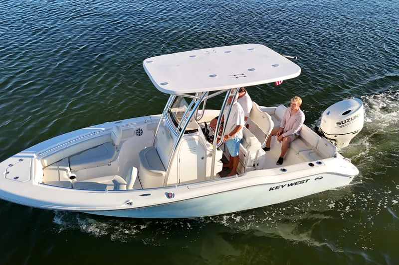 Slide: The Image of 2020 Key West 219 FS boat cruising on water with two passengers. - 7