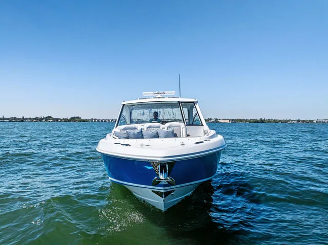 Slide: The Image of 2026 Everglades 367 CX boat docked in harbor under clear sky. - 12