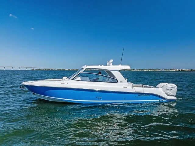 Slide: The Image of Everglades 367 CX 2026 boat docked at marina under blue sky. - 16