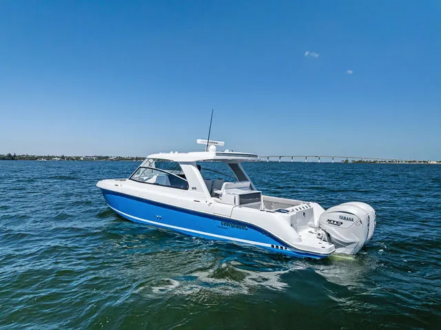 Slide: The Image of 2026 Everglades 367 CX boat docked at marina under sunny skies. - 17