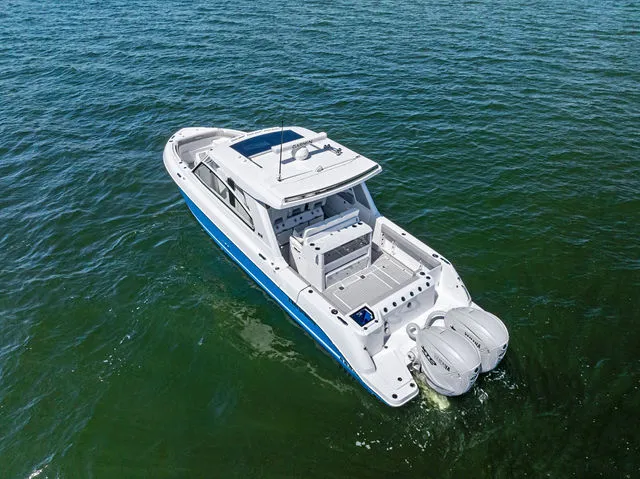 Slide: The Image of 2026 Everglades 367 CX boat docked with twin outboard engines. - 21