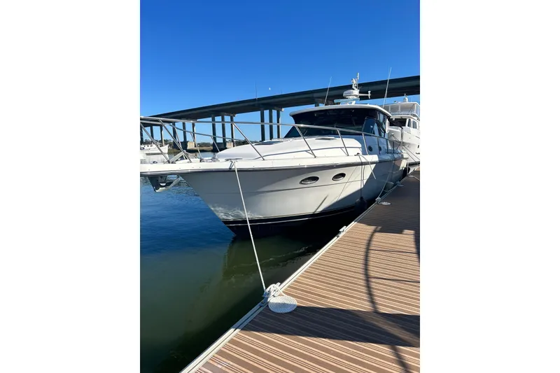 The Image of 1999 Tiara Yachts 4000 Express docked under clear blue sky. - 0