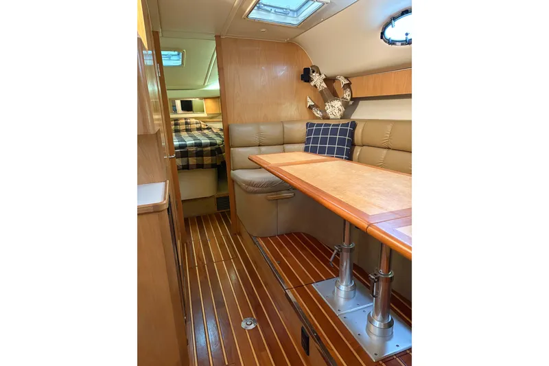 Slide: The Image of Interior of 1999 Tiara Yachts 4000 Express with wood flooring and cozy seating area. - 18