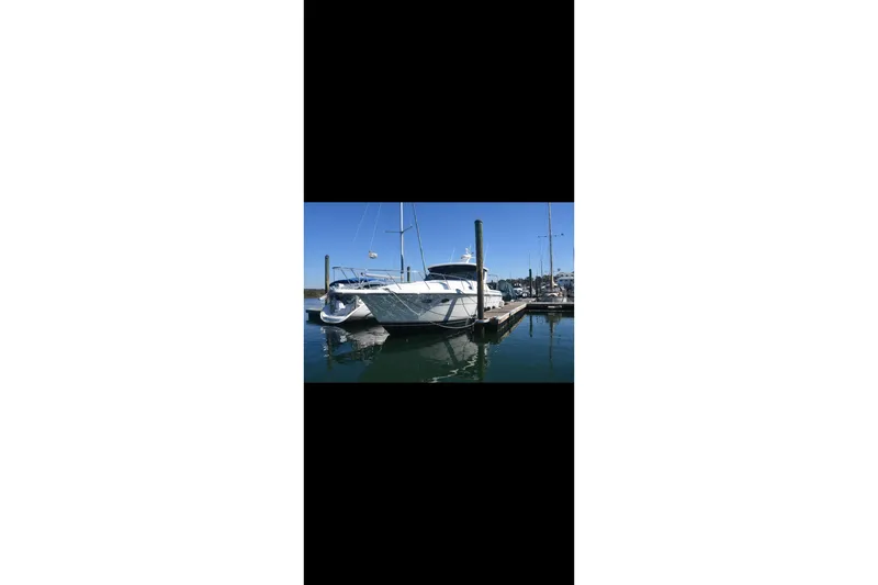 Slide: The Image of Cozy cabin interior of 1999 Tiara Yachts 4000 Express with skylight and checkered bedding. - 20