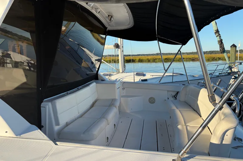 Slide: The Image of 1999 Tiara Yachts 4000 Express docked, featuring sleek design and spacious deck. - 3